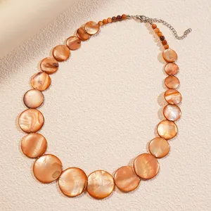 Elegant orange round shell beaded necklace featuring natural luster and adjustable chain