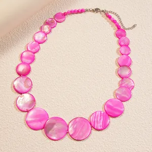 Vibrant pink flat round shell bead necklace featuring a shiny finish and adjustable silver clasp