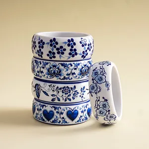 Detail of blue and white floral resin bangles with heart and butterfly motifs