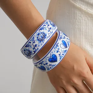 Elegant blue and white porcelain style resin bangles with floral and heart prints on wrist