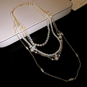 Detail view of multi-layer pearl necklace with elegant gold chain accents
