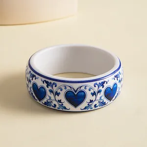 Detailed close-up view of elegant blue and white heart patterns on resin bangle