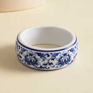 Detailed close-up view of Chinoiserie blue floral pattern on elegant white resin bangle