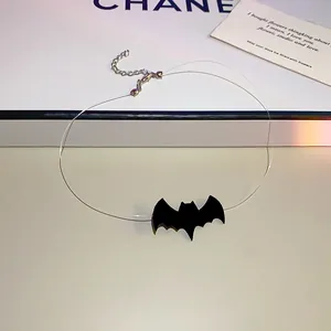 Detailed view of Halloween black bat pendant on a transparent invisible choker chain