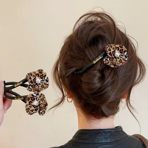 Leopard print flower twist hair clip with pearl for elegant updo styles.