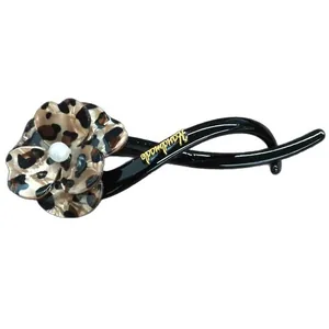 Leopard print flower hair clip featuring a pearl center and handmade gold lettering.