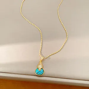 Detailweergave van de vergulde kalebas hanger ketting met blauw turquoise en zirkonia's
