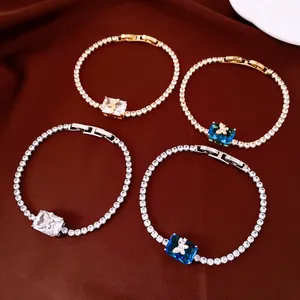 Detailed view of 18k gold plated tennis bracelets with butterfly and square zircon