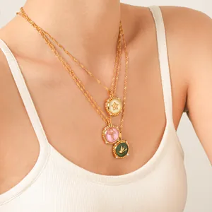 Detail view of layered necklaces featuring colorful oil-drip bow and bird round pendants