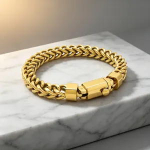 Detail view of a gold stainless steel franco chain bracelet with a square snap clasp