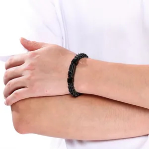 Detail view of men's black stainless steel bracelet featuring a unique square press buckle