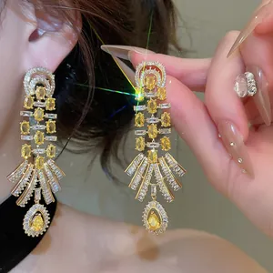 Detailed macro view of 18k gold plated vintage palace style teardrop earrings.