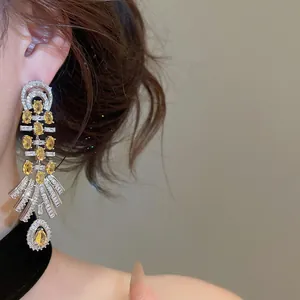 Close-up of vintage palace style 18k gold plated chandelier earrings with yellow zircon stones