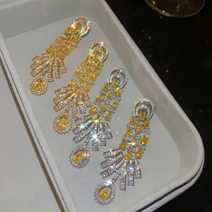 Macro view of vintage court style teardrop earrings with sparkling yellow zircons