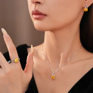 Gedetailleerde macro-opname van een elegante gele zirkoon bloem hanger ketting set op model