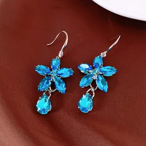 Detailed view of elegant blue floral drop earrings featuring marquise and pear-cut crystals.