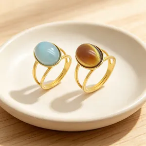 Close-up detail of retro stainless steel rings featuring blue and brown cat-eye stones