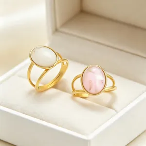 Close-up detail of vintage oval cat's eye stone rings in gold stainless steel