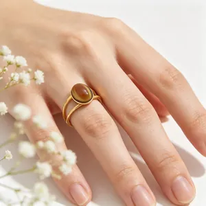 Vintage oval brown cat's eye stone ring featuring a sleek gold double-band design.