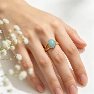 Detailed view of a vintage gold-plated stainless steel ring with a blue oval cat's eye stone
