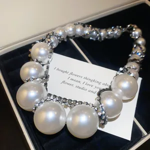 Gros plan d'un collier de perles vintage avec des détails de chaîne en strass brillants