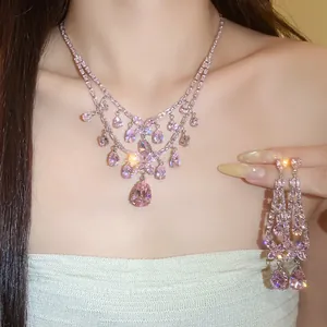 Detailansicht eines funkelnden rosa Zirkon-Blumen-Halsketten- und Ohrring-Sets an einem Modell