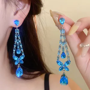 Detailansicht eleganter blauer Zirkon-Ohrhänger mit Schmetterlings- und Tropfenmotiven.