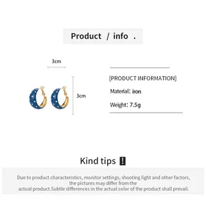 Detailed view of retro blue polka dot hoop earrings featuring size and material information