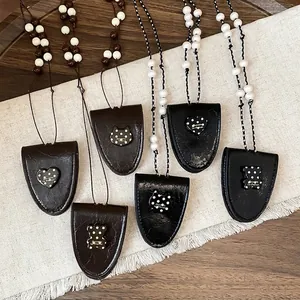 Retro leather pendant necklace featuring heart and bear charms on a stylish beaded cord