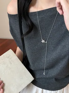 Elegant silver flower pendant Y-necklace styled on a model for a minimalist daily look