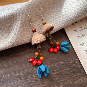 Macro detail of vintage ethnic style tassel earrings crafted from wood and plant seeds
