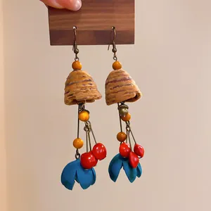Detailed macro view of vintage ethnic wooden earrings featuring colorful nature-inspired tassels