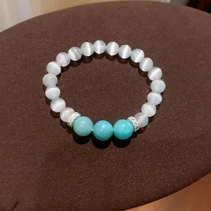 Elegant white cat-eye and turquoise beaded bracelet with silver rhinestone spacers