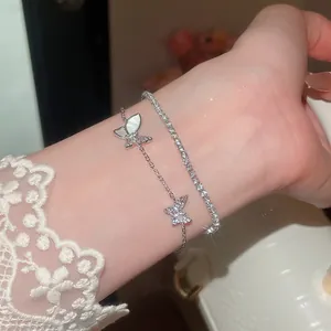 Detailansicht eines zweilagigen Armbands mit Schmetterlingsanhängern und Zirkonia-Kette