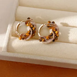 Detailed view of vintage tiger eye beaded twisted hoop earrings in jewelry box
