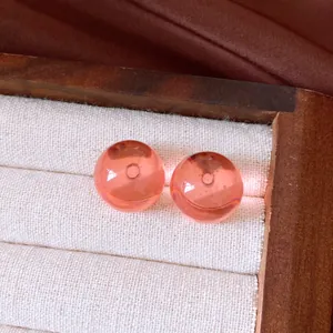 Detailansicht der rosafarbenen, durchscheinenden Kugelstecker im Vintage-Stil in Schmuckschatulle.