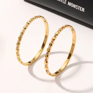 Exquisite detail view of geometric gold stainless steel bangles with colorful zircon inlays