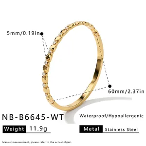 Detail showing 5mm width and 60mm diameter of the gold geometric zircon bracelet