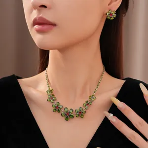 Vintage flower necklace and earrings set with green zircon stones on female model