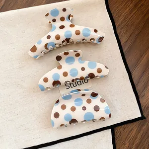 Vintage polka dot hair claw clips in blue and brown, three different retro shark clip shapes