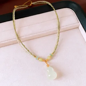 Close-up detail of 18k gold plated double-layer beaded chalcedony gourd necklace with Fu charm