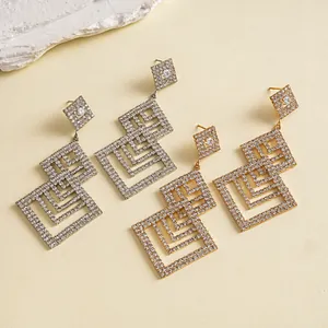 Detailansicht von geometrischen Quadrat-Ohrringen mit Strass in Gold und Silber