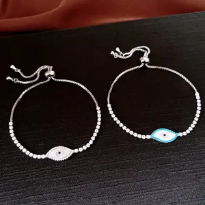 Close-up of delicate evil eye zircon bracelets featuring an adjustable sliding chain design