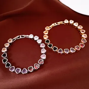 Close-up detail of multi-color heart-shaped zircon bracelets in gold and silver finish