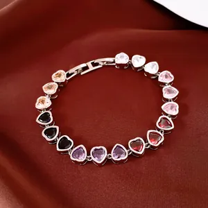 Macro view of heart-shaped multi-color zircon bracelet with silver-tone metal setting