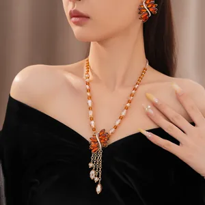 Exquisite detailed view of vintage amber crystal beaded necklace and leaf earring jewelry set