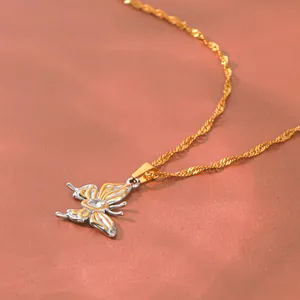 Detailed close-up of a two-tone stainless steel butterfly pendant with sparkling zircon.