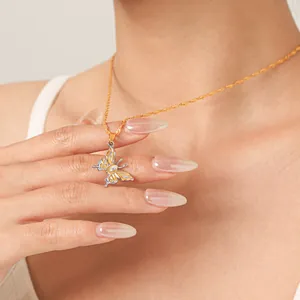 Detailed shot of two-tone stainless steel butterfly pendant necklace with zircon inlay