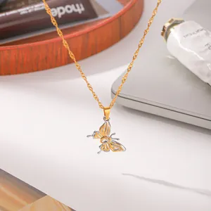Detailed shot of bicolor stainless steel butterfly pendant necklace with zircon stone