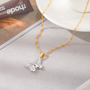 Close-up of a two-tone stainless steel butterfly pendant with zircon on a gold chain